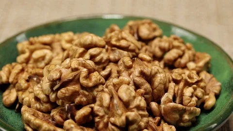 A green plate with walnuts Stock Footage 124133073