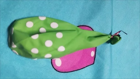 Green Polka Dot Balloon on Blue Background Stock Footage 296035855