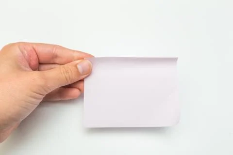 Green post-it note with hand on white background - Image Foto stock