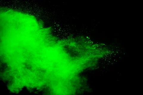 Green powder explosion cloud on black background. Stock Photos
