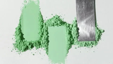 Green powder heaps spread on light gray backdrop Stock Footage 337765197