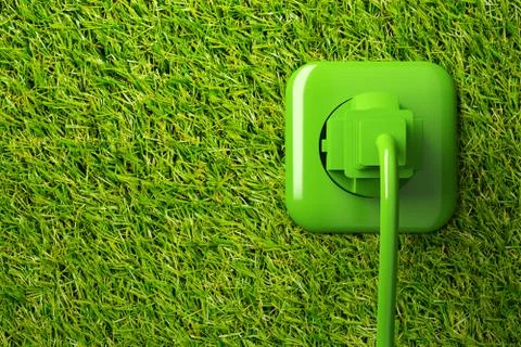 Green power cord in wall socket on grass background with copy space - eco or  Ilustração Stock