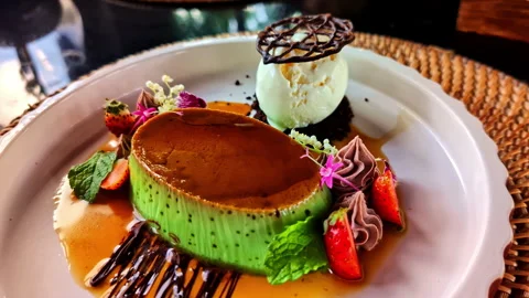 Green pudding creme brulee dessert with ice cream vanilla and strawberry Stock Footage 312243196