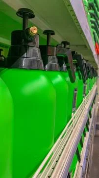 Green pump sprayers on a store window Stock Photos
