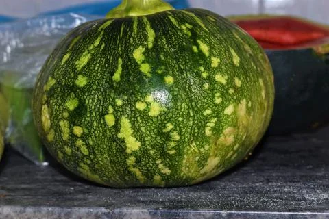Green pumpkin in kitchen closeup background Stock Photos