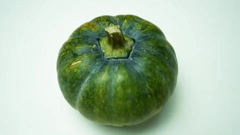 Green Pumpkin on Light Background, A green pumpkin with a smooth surface an.. 動画素材 305045045