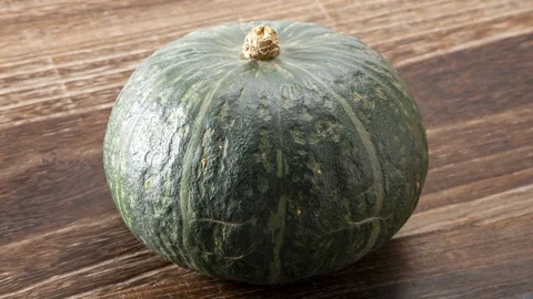 Green Pumpkin On Wooden Surface, Close-Up Shot 4k 스톡 동영상 339281139