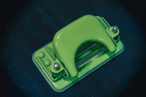 Green Punching machine selective focus on the wooden table Stock Photos