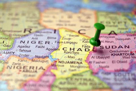 Green Push Pin Highlighting Chad on Blurred World Map Macro Travel Background 스톡 사진