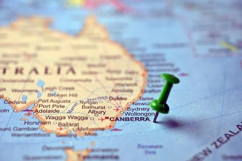 Green Push Pin Marking Canberra on Paper World Map Macro Close Up with Blur.. Stock Photos