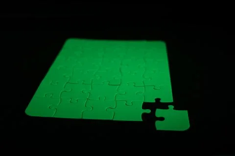 Green puzzle with a corner missing Stock Photos