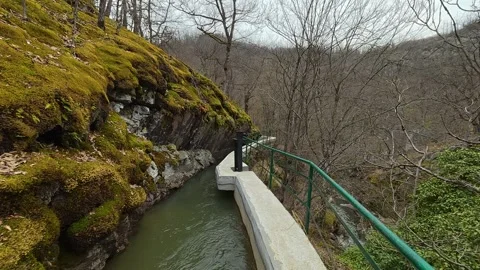 Green railing curves with stream. Vucjanka Canyon, Serbia Видео 332170655