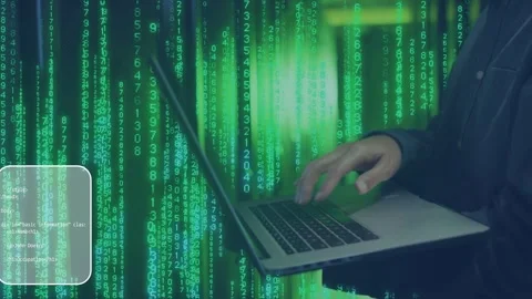 Green rain intensifying, developer typing on laptop as code panels sliding in to Stock Footage 335255200