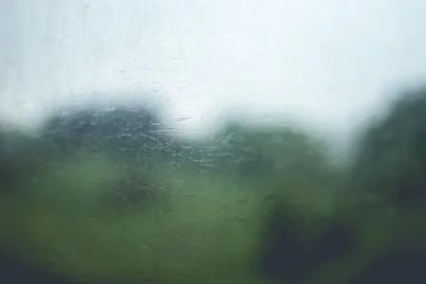 Green rainy fields seen through the old style window in the passenger car. Uk Stock Photos