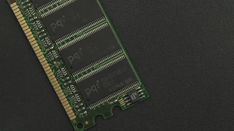 Green RAM Module on Textured Black Surface Stock Footage 336545834
