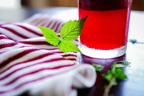 Green raspberry leaves beside refreshment Stock Photos