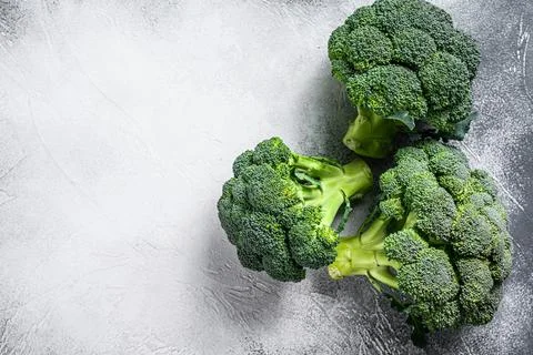 Green raw broccoli cabbage. White background. Top view. Copy space Stock Photos