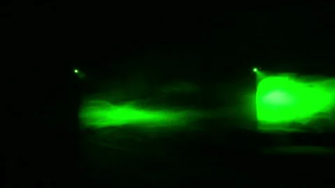 Green rays of light from profile spotlights in the dark in a smoke blanket Stock Footage 112666224