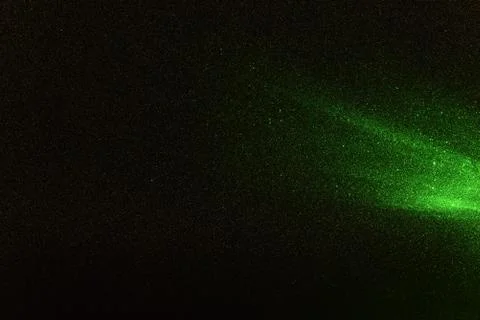 Green rays, lightning and glitter on a black background 스톡 사진