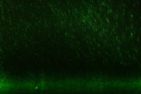 Green rays, lightning and glitter on a black background 스톡 사진