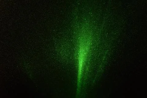 Green rays, lightning and glitter on a black background 스톡 사진