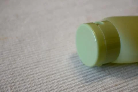 Green Refillable Bottle on White Background, Sustainable Packaging Concept 写真素材