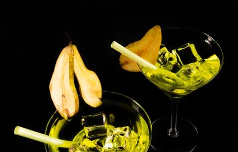 Green refreshing drink on the basis of pear on a black background Stock Photos