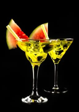 Green refreshing drink on the basis of pear with decorated watermelon on a bl Stock Photos
