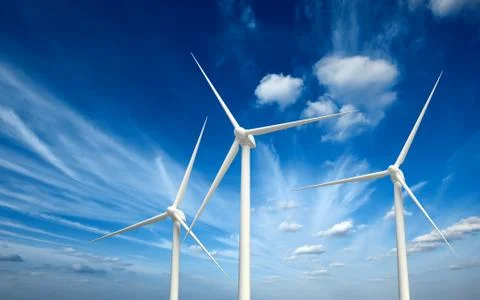 Green renewable energy concept - wind generator turbines in sky Stock Photos