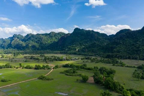 Green rice fields and limestone hills in Laos 스톡 사진