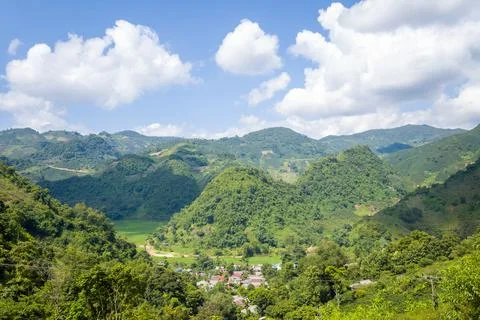 The green rice fields in the middle of forests and karst mountain peaks, in.. Stock Photos