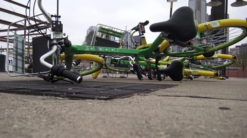 Green Rideshare bikes laying down downtown Video stock 88286505