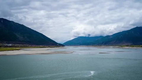Green river channels and pale sandbars beneath Tibetan mountains Stock Footage 345880998