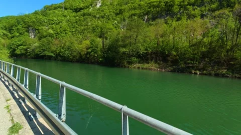 Green river flows calmly beneath metal railing. Ovcar Kalbar Gorge, Serbia Видео 333843702