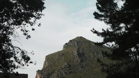 Green rock between trees. Sa Calobra, Spain Stock Footage 133007542