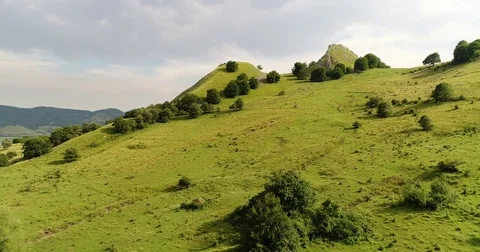 Green rocky hill, low clouds, perfect hiking spot Stock Footage 79264375