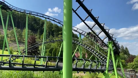 Green roller coaster in an amusement park Stock-Footage 170786611