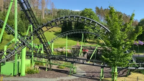 Green roller coaster in an amusement park Stock Footage 170787329