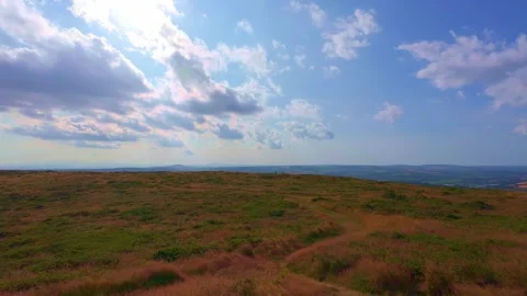 Green rolling hills and valley view on sunny day in Ireland Stock Footage 340435694