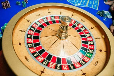 Green roulette table with colored chips ready to play Stock Photos