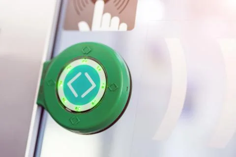 Green round touch button with arrows. Transparent door between carriages in Stock Photos