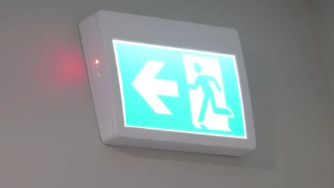Green running man emergency exit sign with battery status light Stock Footage 338233211