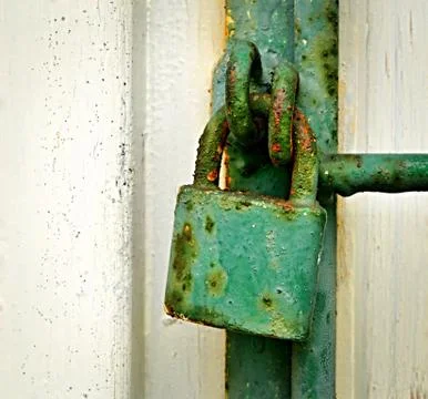 Green rusty iron padlock Stock Photos