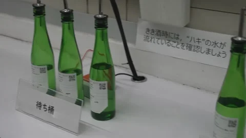 Green Sake Bottles Displayed at a Tasting Station 動画素材 340010536