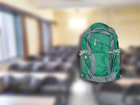 Green school bag isolated on blur classroom Stock Illustration