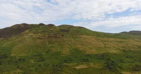 Green Scottish Hill with White Clouds Pull Back Drone Shot 스톡 동영상 97572234