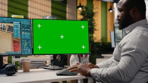 Green screen and architectural software on dual monitors in creative agency 写真素材