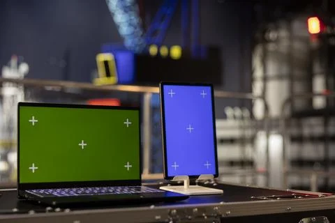 Green screen and blue screen on tablet and laptop on empty oil platform Stock Photos