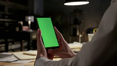 Green Screen and Chroma Key of Smartphone. Business Man Holding Smart Phone and Video stock 199481102