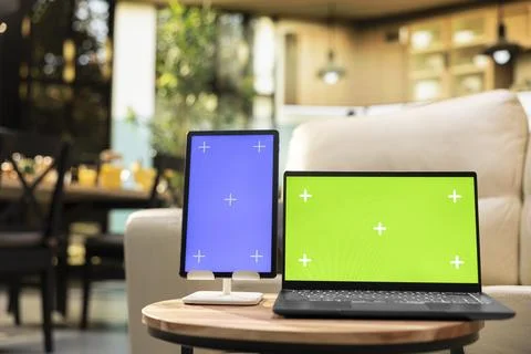 Green screen and vertical blue screen in home interior with coffee table Stock Photos